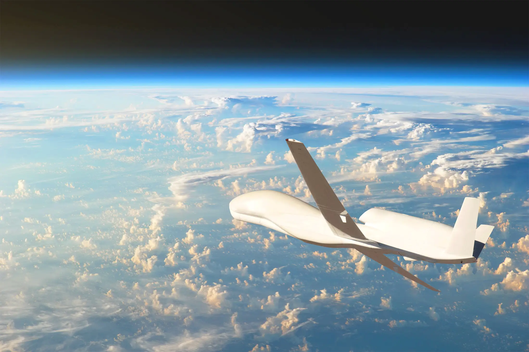High-altitude unmanned aerial vehicle (UAV) flying above the clouds at the edge of Earth’s atmosphere, with the planet’s curvature and dark space visible above the horizon.